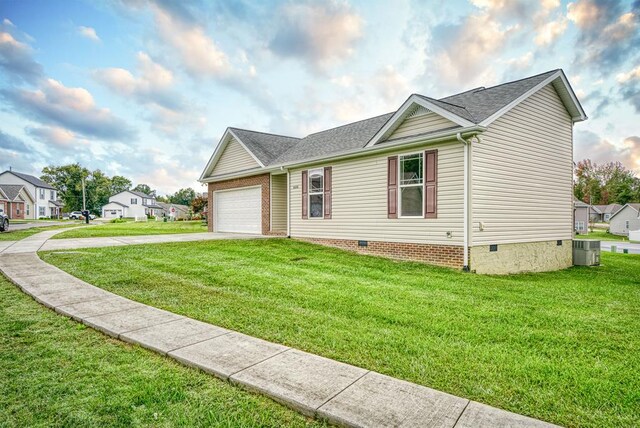 ranch-style home with a front yard, crawl space, central AC, and concrete driveway