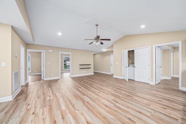 unfurnished living room featuring lofted ceiling, ceiling fan, visible vents, light wood finished floors, and washer / dryer