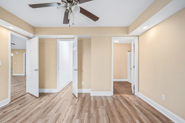 unfurnished bedroom with light wood-style flooring, baseboards, and a ceiling fan