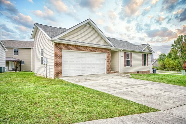 single story home with a garage, concrete driveway, cooling unit, a front lawn, and brick siding