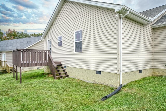 view of home's exterior with crawl space, a lawn, and a wooden deck