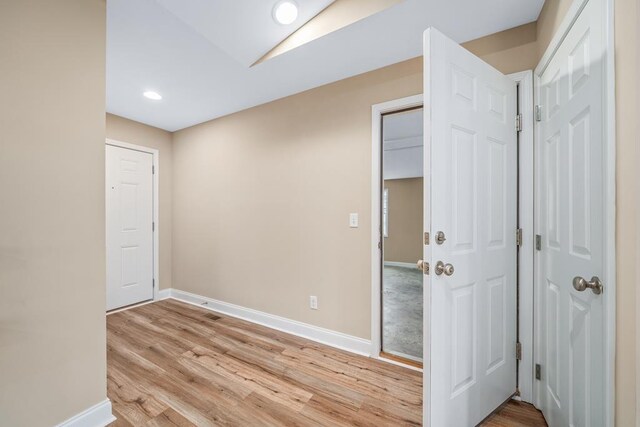 empty room with recessed lighting, baseboards, and light wood finished floors