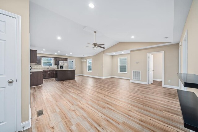 unfurnished living room with lofted ceiling, light wood finished floors, visible vents, and recessed lighting