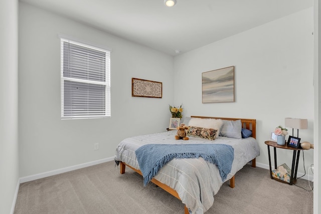 carpeted bedroom featuring baseboards