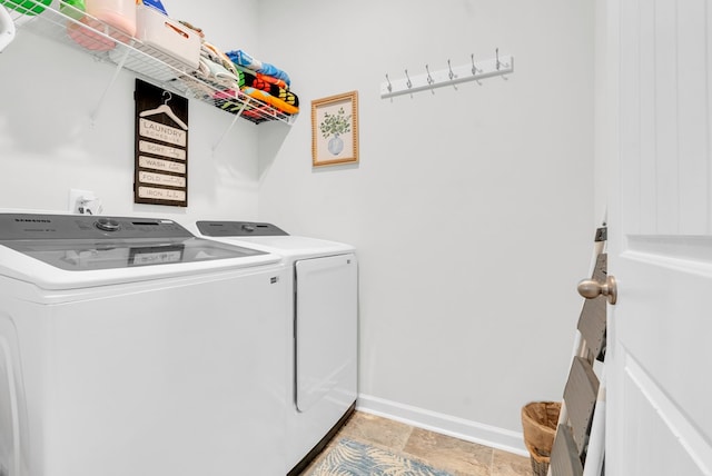 laundry area featuring laundry area, washing machine and dryer, and baseboards