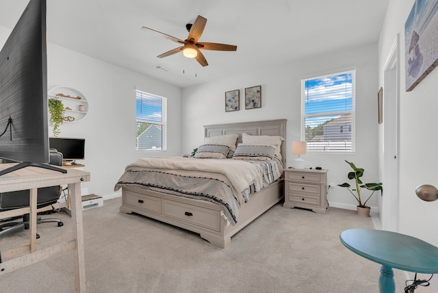 bedroom featuring a ceiling fan, light carpet, visible vents, and baseboards