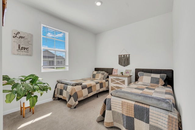 carpeted bedroom with baseboards