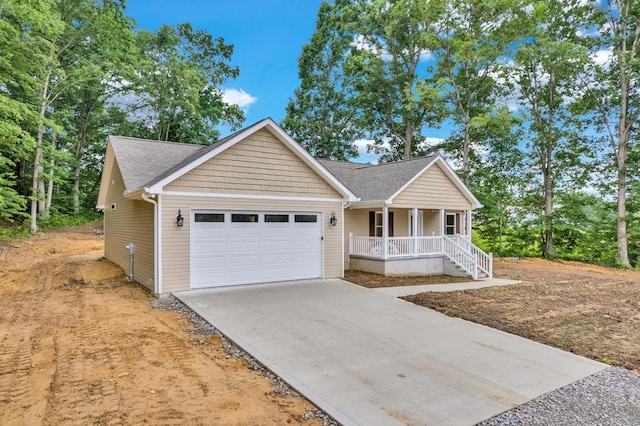 ranch-style house featuring a garage, covered porch, roof with shingles, and concrete driveway