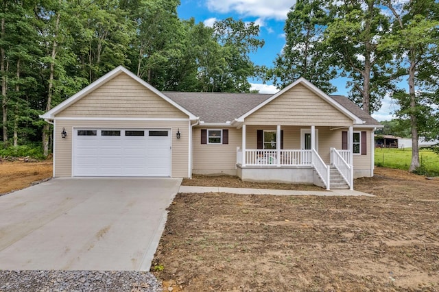 single story home featuring a porch, roof with shingles, driveway, and a garage