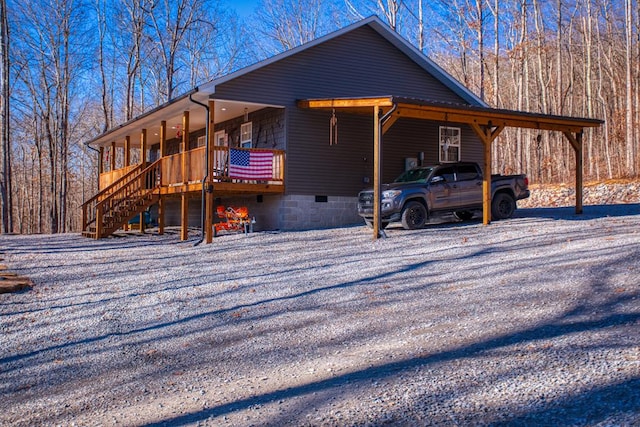 view of property exterior with a carport, crawl space, and stairway