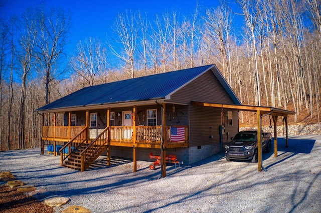 chalet / cabin with a porch, crawl space, metal roof, a carport, and stairs