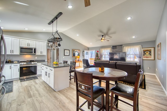 kitchen featuring appliances with stainless steel finishes, a kitchen island, white cabinetry, and pendant lighting