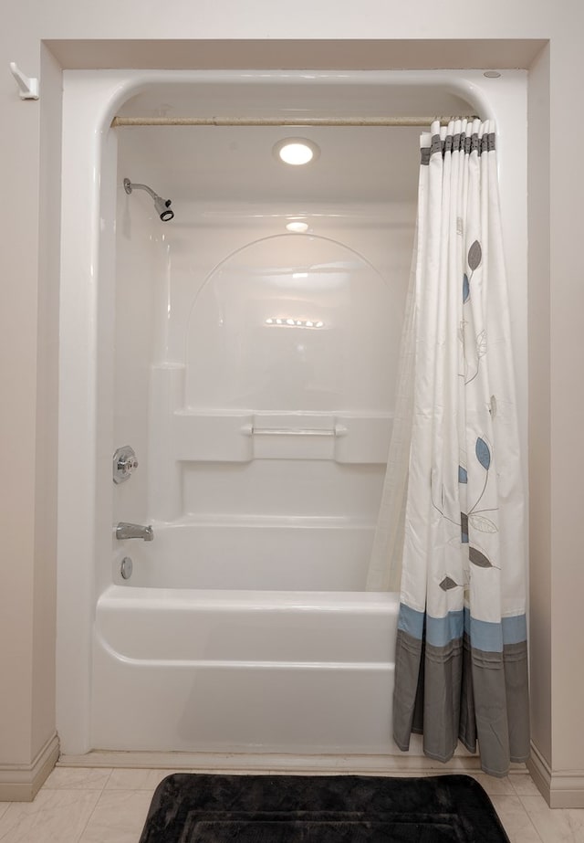 full bath with shower / bath combo and baseboards