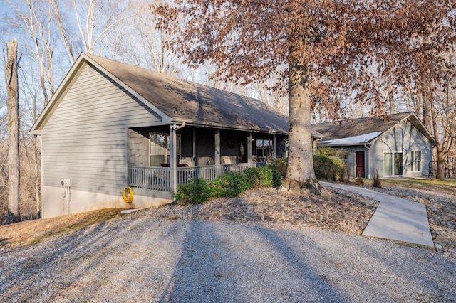 view of front of property with a porch and roof with shingles