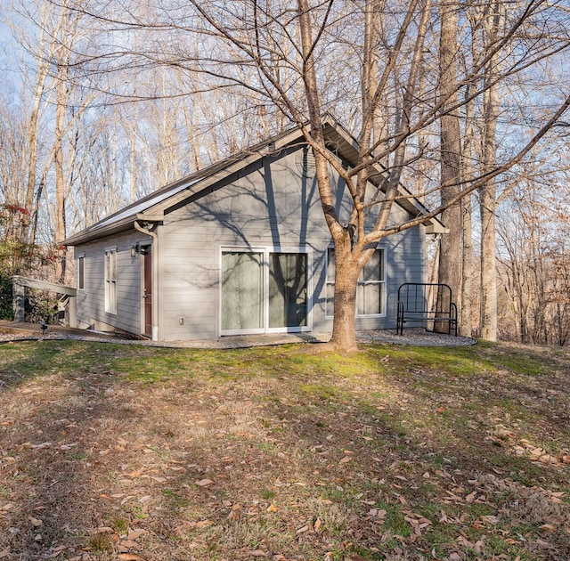 rear view of house with a lawn