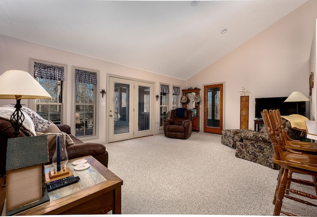 living room featuring high vaulted ceiling, french doors, and carpet flooring