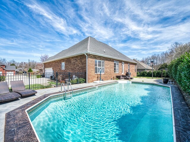 view of pool with a patio area, fence, and a fenced in pool