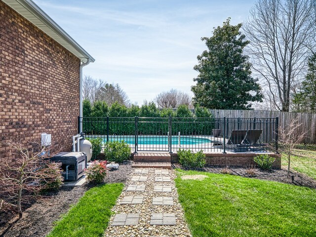 view of pool featuring a fenced backyard, a patio, a fenced in pool, and a yard