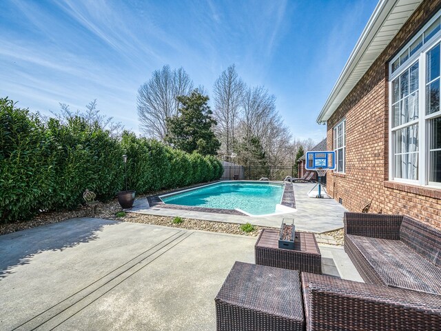 view of swimming pool with a patio, a fenced backyard, an outdoor living space, and a fenced in pool