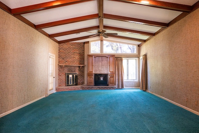 unfurnished living room with wallpapered walls, a ceiling fan, vaulted ceiling with beams, carpet floors, and a fireplace