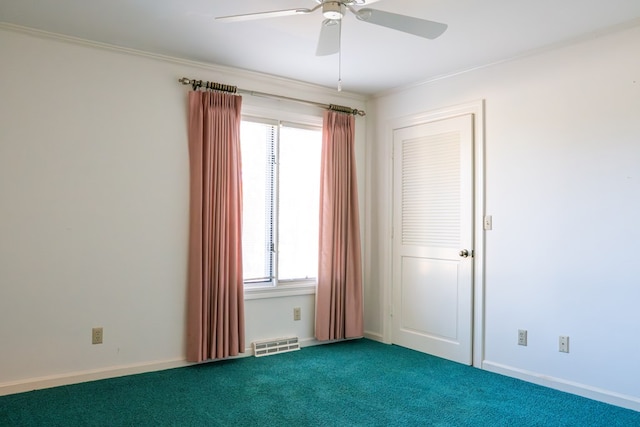 empty room featuring carpet floors, ceiling fan, visible vents, and baseboards