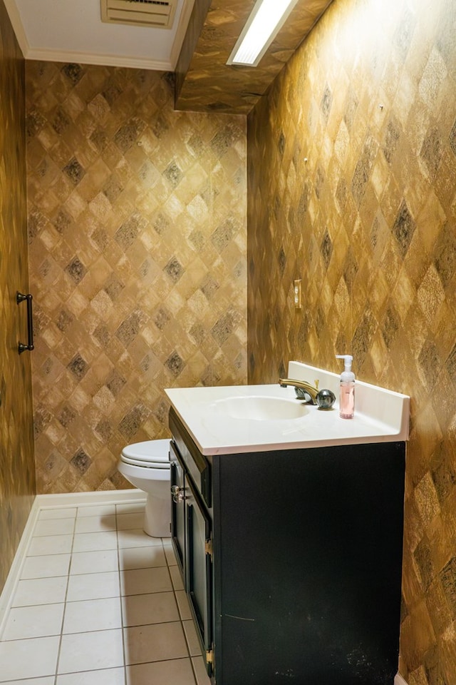 bathroom featuring toilet, vanity, and tile patterned floors