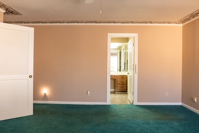 unfurnished bedroom with ornamental molding, carpet flooring, and baseboards