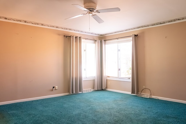 carpeted empty room featuring visible vents, ceiling fan, and baseboards