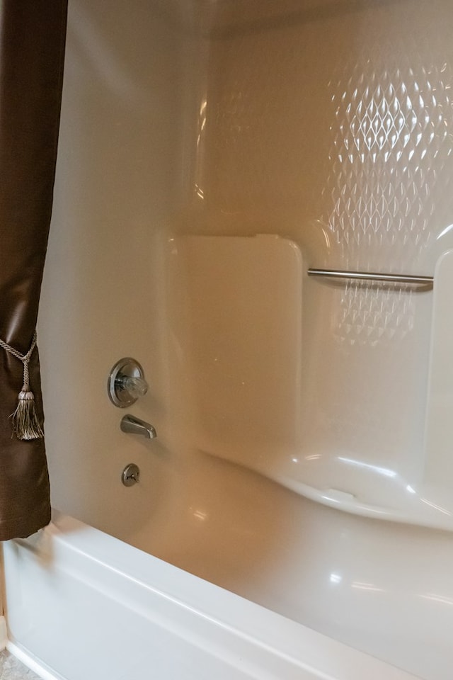 room details featuring washtub / shower combination