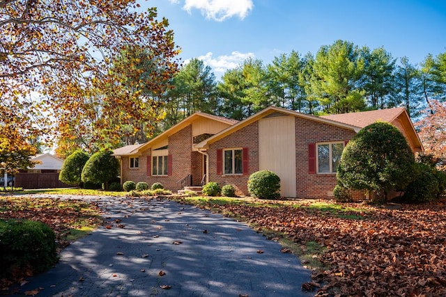 view of front of home with brick siding and fence