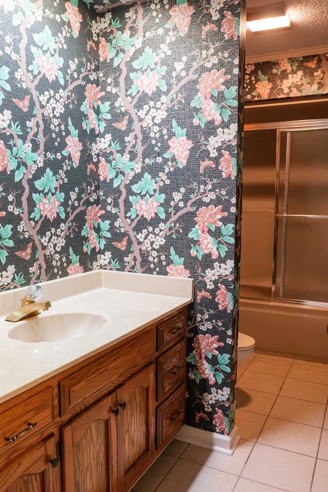 bathroom featuring a textured ceiling, vanity, toilet, and tile patterned floors