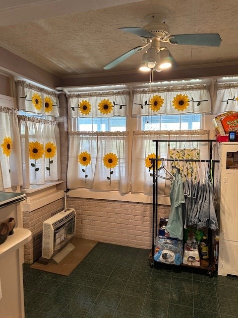 interior space featuring a ceiling fan and heating unit