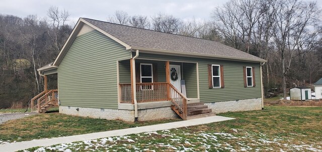 view of front of home featuring a front yard, crawl space, roof with shingles, and covered porch