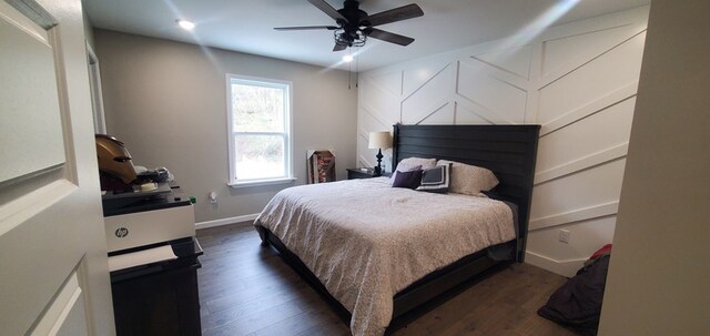 bedroom featuring ceiling fan, baseboards, and dark wood-style flooring