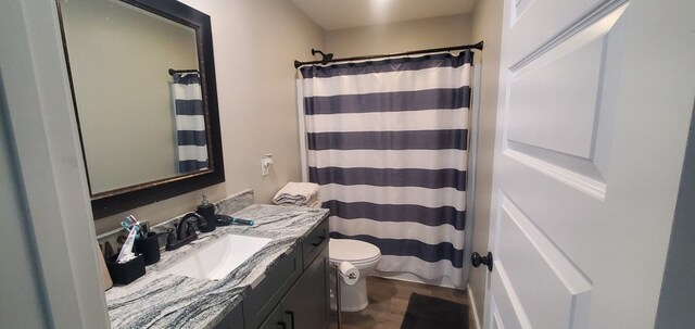 full bathroom with toilet, wood finished floors, vanity, and a shower with curtain