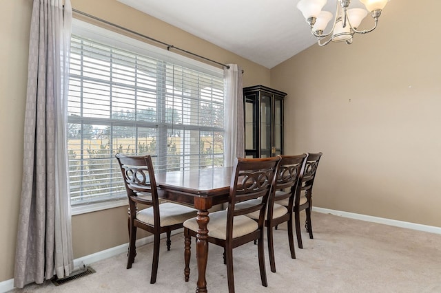 dining area with a chandelier, visible vents, light carpet, and baseboards