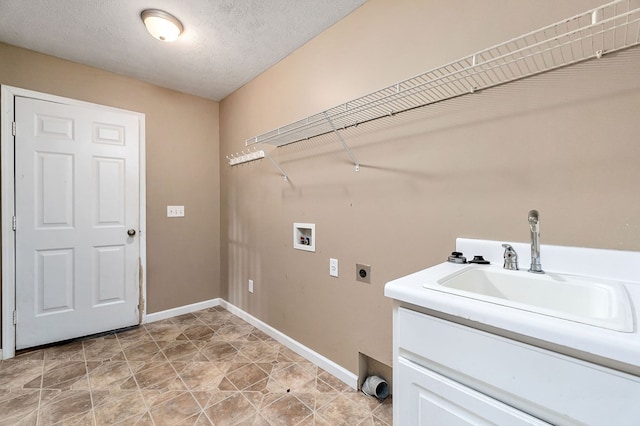 washroom featuring a textured ceiling, hookup for an electric dryer, laundry area, washer hookup, and a sink