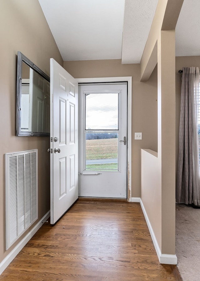 entryway featuring baseboards, visible vents, and dark wood-style flooring