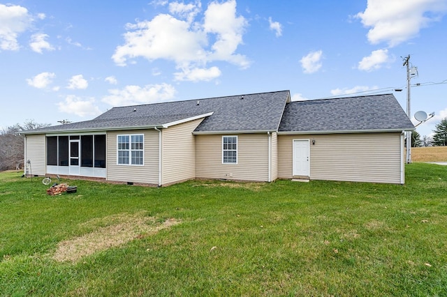 rear view of house featuring a shingled roof, crawl space, a yard, and a sunroom