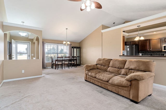 living room with light carpet, vaulted ceiling, ceiling fan with notable chandelier, and baseboards