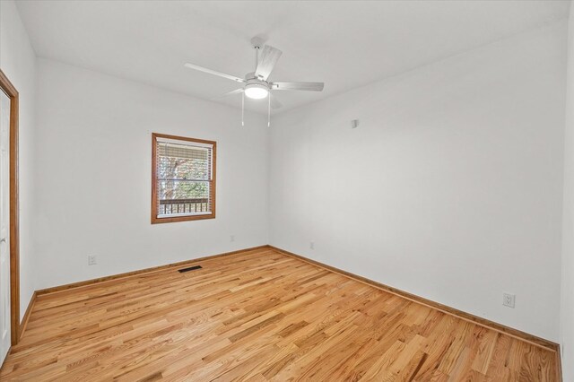 unfurnished room with ceiling fan, baseboards, visible vents, and light wood-style floors