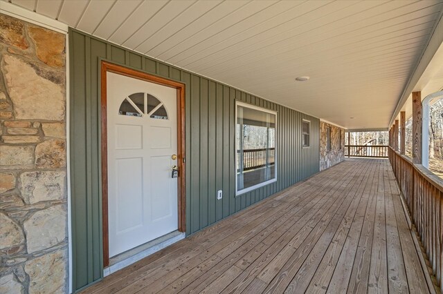 exterior space with stone siding and covered porch