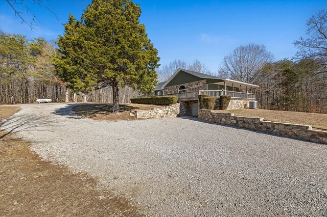 view of front of house featuring gravel driveway and cooling unit