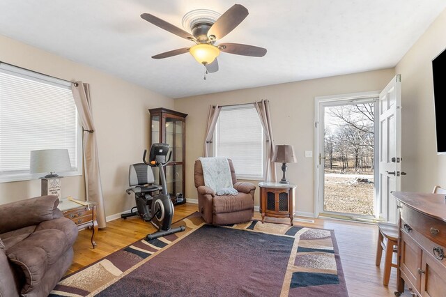 sitting room with light wood-style floors, ceiling fan, and baseboards