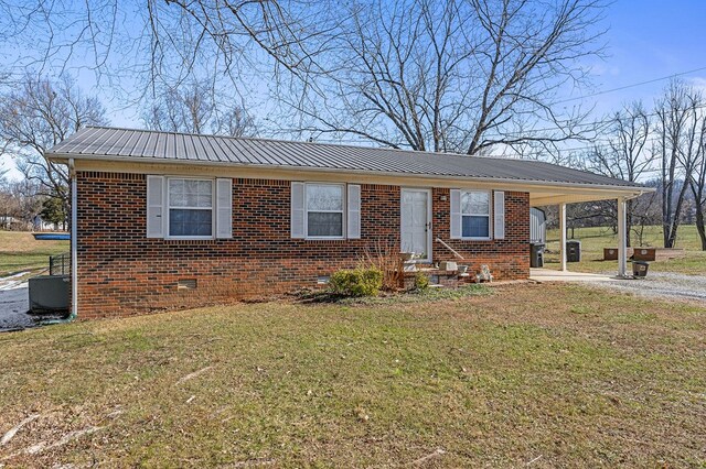 view of front of home with a carport, brick siding, crawl space, and a front yard