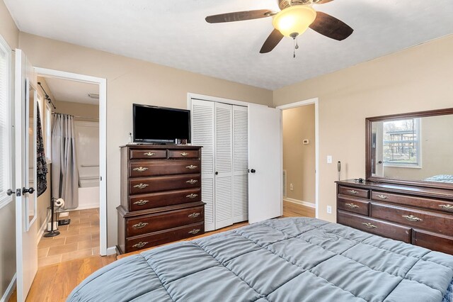 bedroom with baseboards, a closet, a ceiling fan, and light wood-style floors