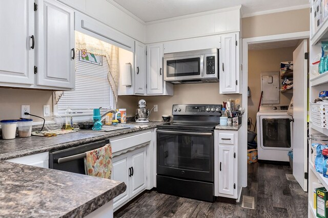 kitchen featuring black range with electric stovetop, white cabinetry, stainless steel microwave, dark countertops, and washer / dryer