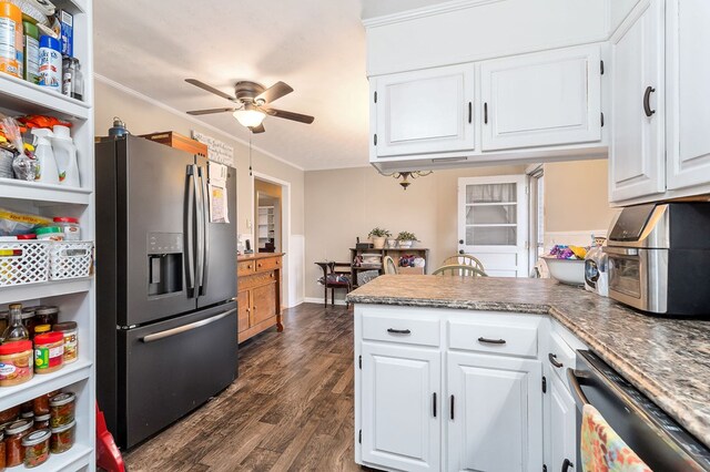 kitchen with dark wood-style flooring, crown molding, stainless steel appliances, white cabinets, and a peninsula