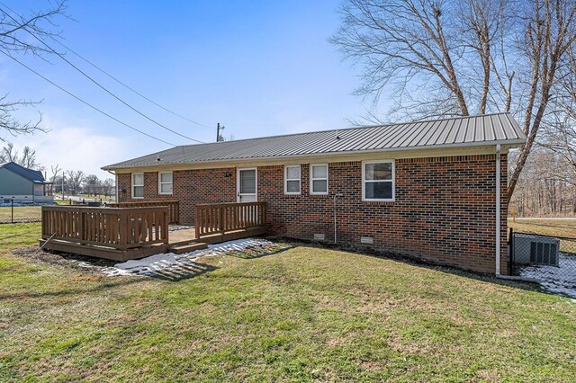 back of property featuring crawl space, a yard, a deck, and brick siding