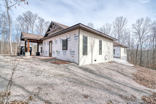 view of side of property featuring a shingled roof and a porch